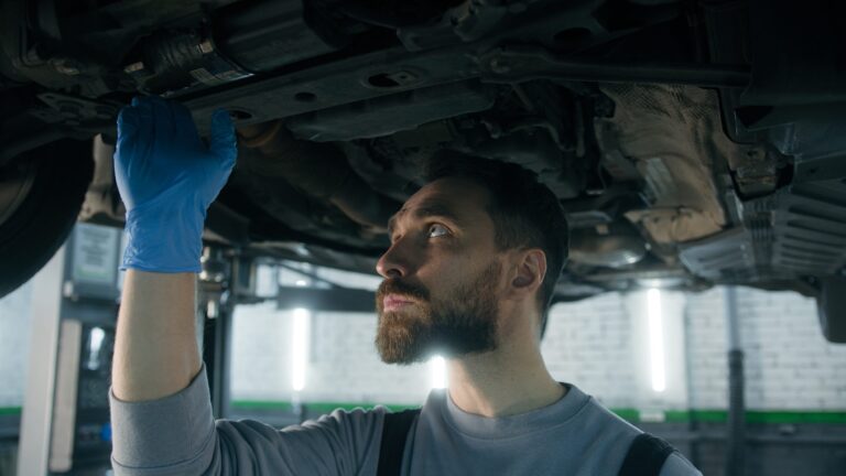 Service director reviewing warranty labor rate reports at an automotive dealership