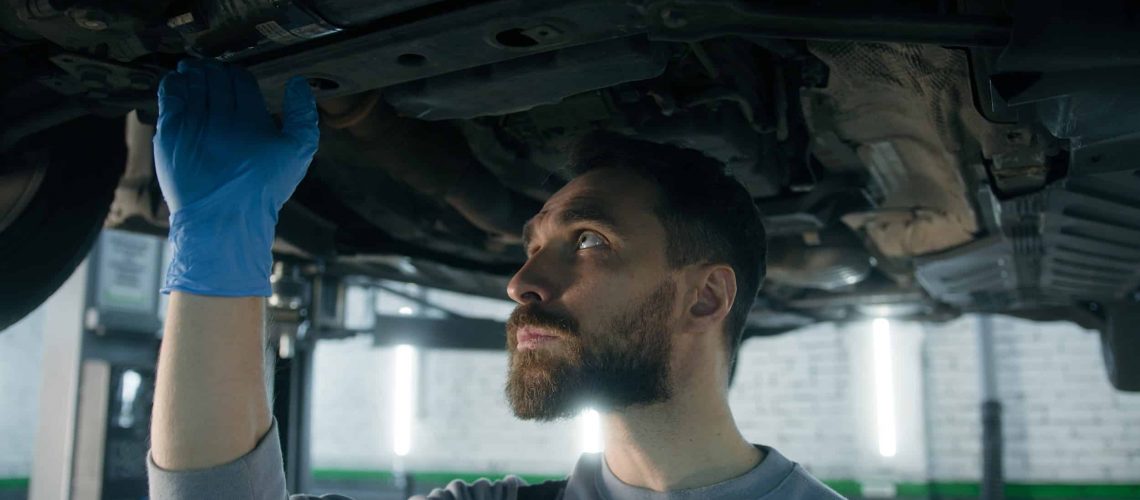 Service director reviewing warranty labor rate reports at an automotive dealership